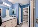 Modern bathroom featuring blue walls, a white vanity, and tiled walk-in shower at 10511 W 101St Ave, Broomfield, CO 80021