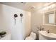 Cozy powder room features flower wall decor, white vanity, and modern fixtures at 10511 W 101St Ave, Broomfield, CO 80021