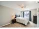 Comfortable bedroom featuring carpet, a large window with blue curtains, and neutral walls at 10511 W 101St Ave, Broomfield, CO 80021