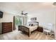 Comfortable bedroom with ceiling fan and a large window to view the greenery outside at 10511 W 101St Ave, Broomfield, CO 80021