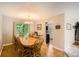Elegant dining room with hardwood floors, a large wooden table and a view to the kitchen at 10511 W 101St Ave, Broomfield, CO 80021