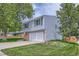 Charming two-story home with a well-maintained lawn, attached two-car garage, and mature trees at 10511 W 101St Ave, Broomfield, CO 80021