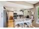 Open concept kitchen with granite counters, white cabinets, stainless appliances, and a breakfast bar at 10511 W 101St Ave, Broomfield, CO 80021