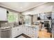 Stylish kitchen featuring granite countertops, white cabinets, and stainless steel appliances at 10511 W 101St Ave, Broomfield, CO 80021