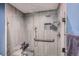 Stylish tiled shower with glass door, hand-held shower head, and built-in niche at 10511 W 101St Ave, Broomfield, CO 80021