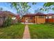 Spacious backyard featuring a lush lawn, pergola, and greenhouse at 1312 Ash St, Denver, CO 80220
