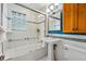 Bathroom featuring white subway tile, a glass-enclosed shower, and a pedestal sink at 1312 Ash St, Denver, CO 80220