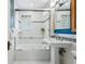 Clean bathroom with a glass-enclosed shower and white tiling at 1312 Ash St, Denver, CO 80220