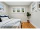 Bedroom with hardwood floors and three windows that provide ample natural light at 1312 Ash St, Denver, CO 80220