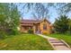 Attractive home with lush green lawn and mature trees, nestled in a quiet neighborhood at 1312 Ash St, Denver, CO 80220