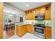 Charming kitchen with stainless steel oven, view of dining area, and stylish backsplash at 1312 Ash St, Denver, CO 80220