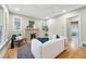 Cozy living room showcasing a charming fireplace and large windows for natural light at 1312 Ash St, Denver, CO 80220
