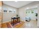 Bright home office with hardwood floors, a desk, and a doorway into a bedroom at 1312 Ash St, Denver, CO 80220