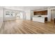 Spacious living space with wood-look flooring, a kitchen, and abundant natural light at 3411 N Denali St, Aurora, CO 80019
