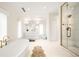 Contemporary bathroom showcasing a standalone tub, glass shower, and sleek double vanity at 181 Race St, Denver, CO 80206