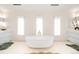 Luxurious bathroom with a soaking tub, twin vanities, and natural light from three large windows at 181 Race St, Denver, CO 80206