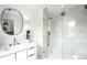 Modern bathroom featuring a glass shower, stylish vanity, and an oval mirror, providing a serene and elegant space at 181 Race St, Denver, CO 80206