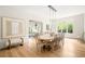 Dining room and living room with hardwood floors and white walls adjacent to a large set of windows at 181 Race St, Denver, CO 80206