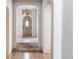 Inviting entryway featuring arched doorways, stone flooring, and a unique wooden door with decorative chandelier at 181 Race St, Denver, CO 80206