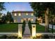 Elegant home exterior showcasing manicured lawn, gated entrance, and warm lighting, adding to its curb appeal at 181 Race St, Denver, CO 80206