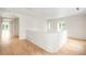 Inviting hallway with hardwood floors, archways, and an abundance of natural light at 181 Race St, Denver, CO 80206