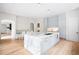 Open kitchen featuring a large marble island, stainless steel appliances and light gray cabinetry at 181 Race St, Denver, CO 80206
