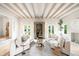 Bright living room featuring hardwood floors, beamed ceilings, and french doors leading to the outside at 181 Race St, Denver, CO 80206