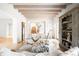 Spacious living room with hardwood floors, beamed ceilings and a fireplace, adjacent to the staircase and entryway at 181 Race St, Denver, CO 80206