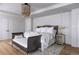 Bedroom with a stylish chandelier, unique furniture and white bedding at 181 Race St, Denver, CO 80206