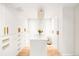 Organized walk-in closet with custom shelving, drawers, and a stunning chandelier at 181 Race St, Denver, CO 80206