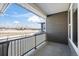 Outdoor balcony with grey privacy screen and view of snow covered landscape in the distance at 350 High Point Dr # C201, Longmont, CO 80504