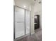 Bright bathroom features a tiled shower with a glass door, a built-in seat, and dark cabinets at 350 High Point Dr # C201, Longmont, CO 80504