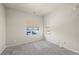 Bright bedroom boasts plush carpet, neutral paint, and dual windows offering exterior views at 350 High Point Dr # C201, Longmont, CO 80504