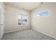 Bedroom boasts carpet, neutral paint, windows with exterior views, and a large door at 350 High Point Dr # C201, Longmont, CO 80504