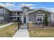 Charming townhouse with gray siding, stone accents, a black fence, and well-maintained landscaping at 350 High Point Dr # C201, Longmont, CO 80504