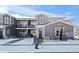 Gray townhome complex with black wrought iron railings in a snowy landscape under a blue sky at 350 High Point Dr # C201, Longmont, CO 80504