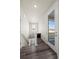 Hallway view with stylish wood floors, a stairway to basement and large glass door to outdoor space at 350 High Point Dr # C201, Longmont, CO 80504