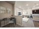Bright living room with a desk area that flows into the cozy living space and modern kitchen at 350 High Point Dr # C201, Longmont, CO 80504
