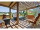 Covered backyard deck with hot tub, seating, and a fire pit at 4077 Forever Cir, Castle Rock, CO 80109