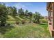Expansive backyard with lush lawn, mature trees, and tasteful landscaping, offering a serene outdoor space at 4077 Forever Cir, Castle Rock, CO 80109