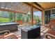Cozy covered patio area with a hot tub, outdoor furniture, and a scenic view at 4077 Forever Cir, Castle Rock, CO 80109