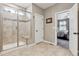 Bathroom featuring glass shower, neutral tile and seat, as well as view into bedroom at 4077 Forever Cir, Castle Rock, CO 80109