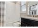Bathroom featuring tiled shower and tub, decorative mirror, and granite vanity at 4077 Forever Cir, Castle Rock, CO 80109