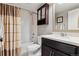 Bathroom featuring a shower-tub combo, tile surround, and a vanity at 4077 Forever Cir, Castle Rock, CO 80109