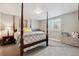 Bedroom with natural light with neutral tones, a four-poster bed, and gray carpet at 4077 Forever Cir, Castle Rock, CO 80109