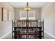 Dining room showcasing stylish light fixture, neutral paint, and an elegant wood dining table set for eight at 4077 Forever Cir, Castle Rock, CO 80109