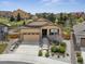 Charming home featuring a well-manicured front yard and attached two-car garage with stone accents at 4077 Forever Cir, Castle Rock, CO 80109