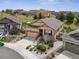 An exterior shot shows a home with a two-car garage, landscaping, and other neighborhood homes in the background at 4077 Forever Cir, Castle Rock, CO 80109