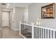A freshly painted hallway featuring newly installed wood floors, white trim, and modern light fixtures at 4077 Forever Cir, Castle Rock, CO 80109