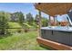 Backyard with a relaxing hot tub, wooden deck and landscaped yard for outdoor enjoyment at 4077 Forever Cir, Castle Rock, CO 80109